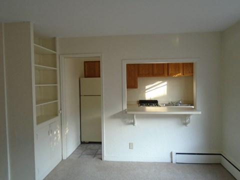 a view of a kitchen with a sink and a refrigerator